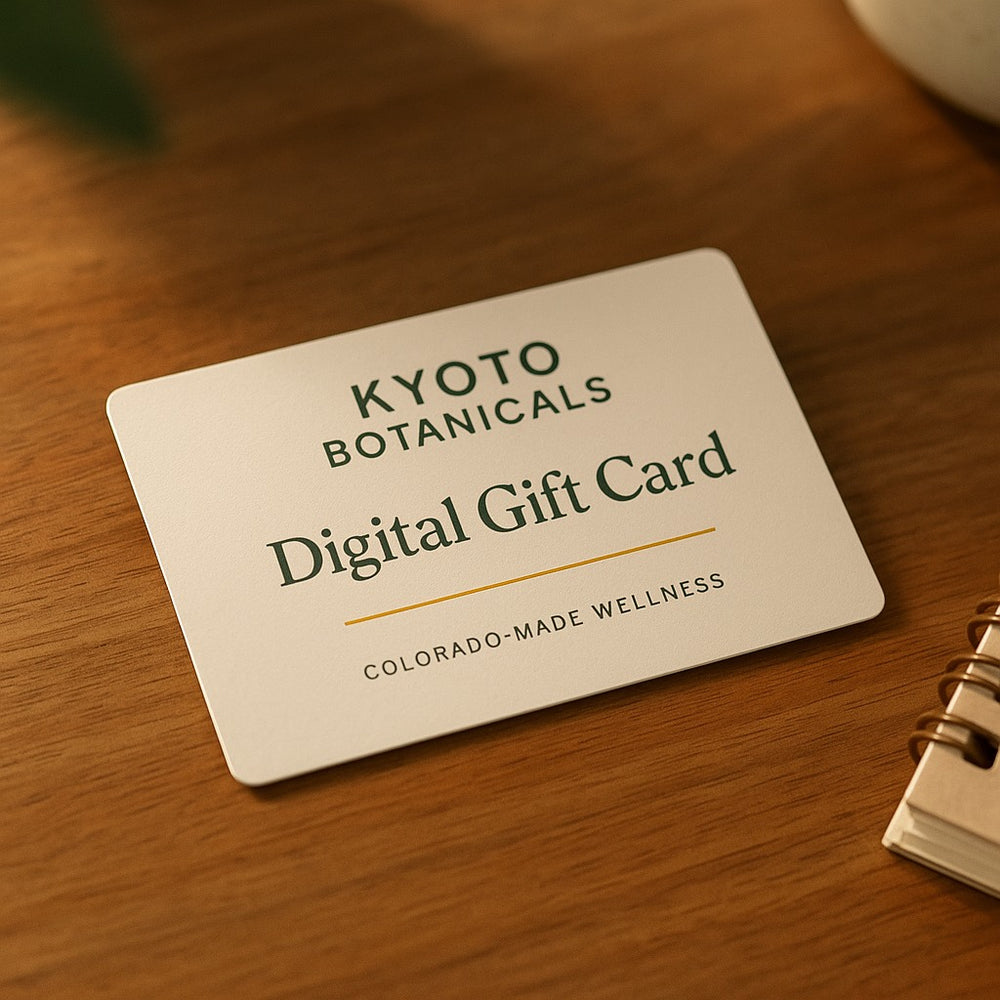 Kyoto Botanicals Digital Gift Card displayed on a natural wood table in soft Colorado morning light